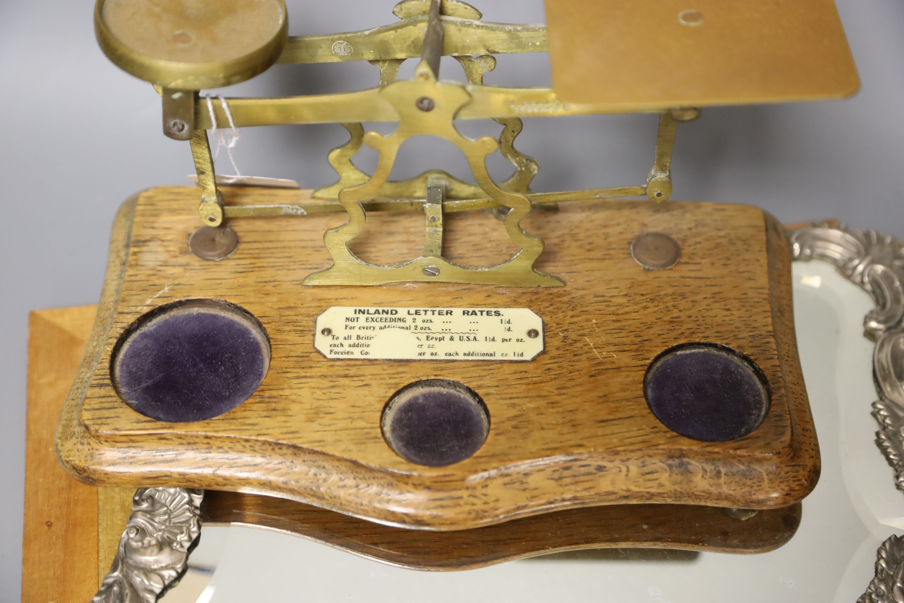 A set of postal scales, a white metal overlaid easel mirror, length 36.5cm, and a carved wood panel